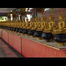 In die Gefäße vor den Buddhafiguren spendet man Münzen für die Mönche